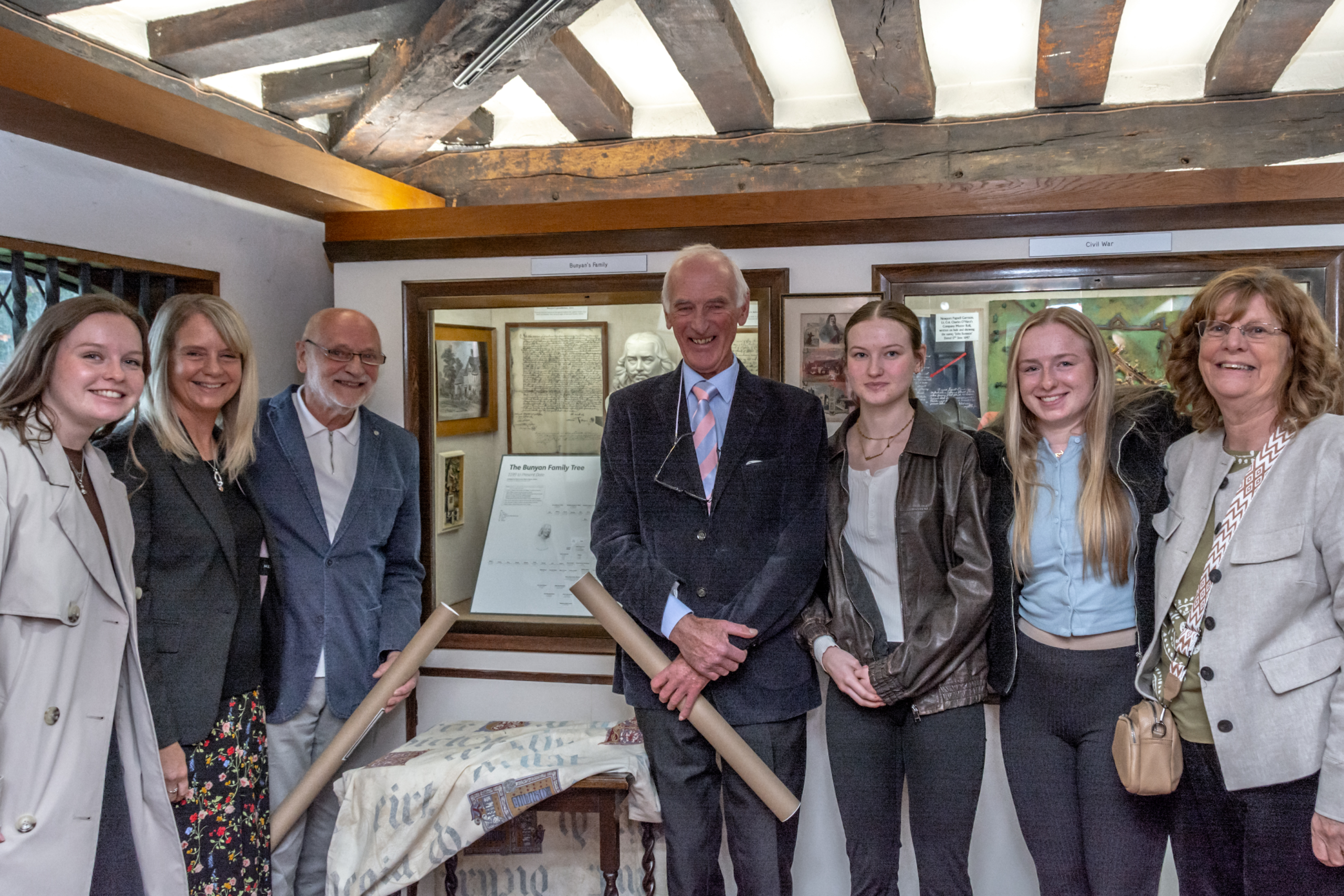 The Brown family stand by the recently updated John Bunyan family tree